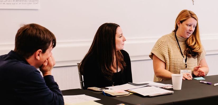 A group of 3 people working together