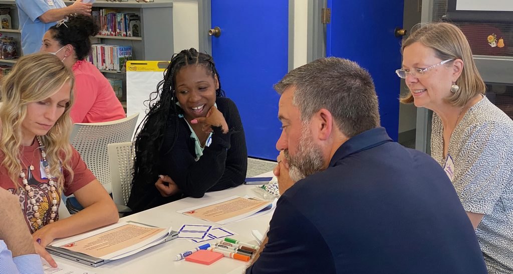4 people collaborating at a table